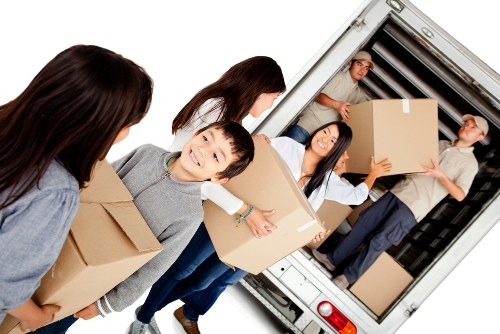Professional flat removals in Croydon with moving van outside an apartment block