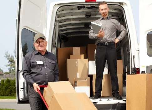 Team planning office removals in Croydon with moving boxes and desks